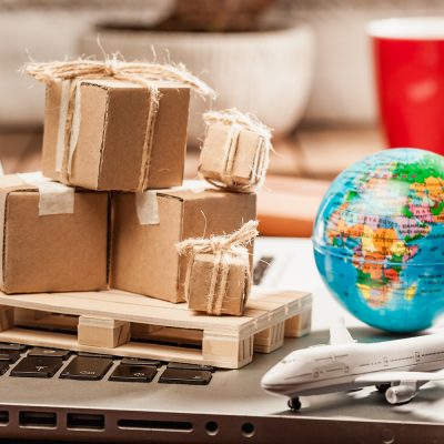 Global logistics concept with online trading and shopping in the internet, packages to be delivered after ordering on the computer